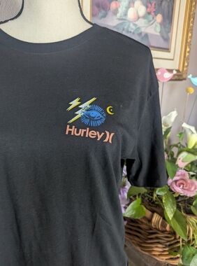 BNWOT Hurley Black Tee with Blue Eye and Yellow Lightning.